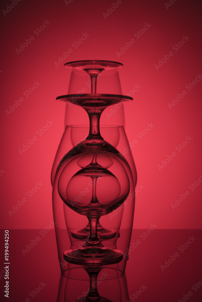 Glasses standing in a row on a red background. Glasses standing in a row on a red background.