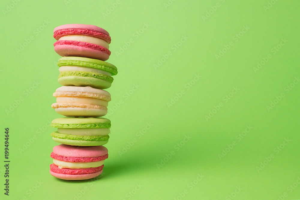 Colored macaroons row on green background Colored macaroons row on green background