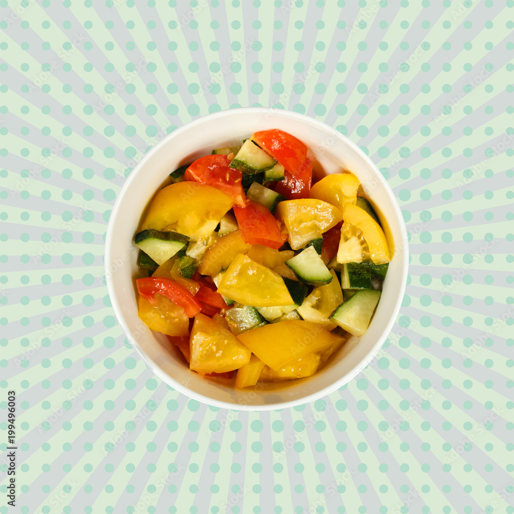 Vegetable salad of cucumbers and tomatoes in a white cup on a colored background