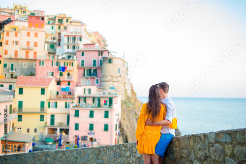 Happy couple background stunning village of Manarola, Cinque Terre, Liguria, Italy
