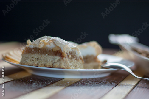 Square shape sliced omemade apple pie with kumquats and almonds photo