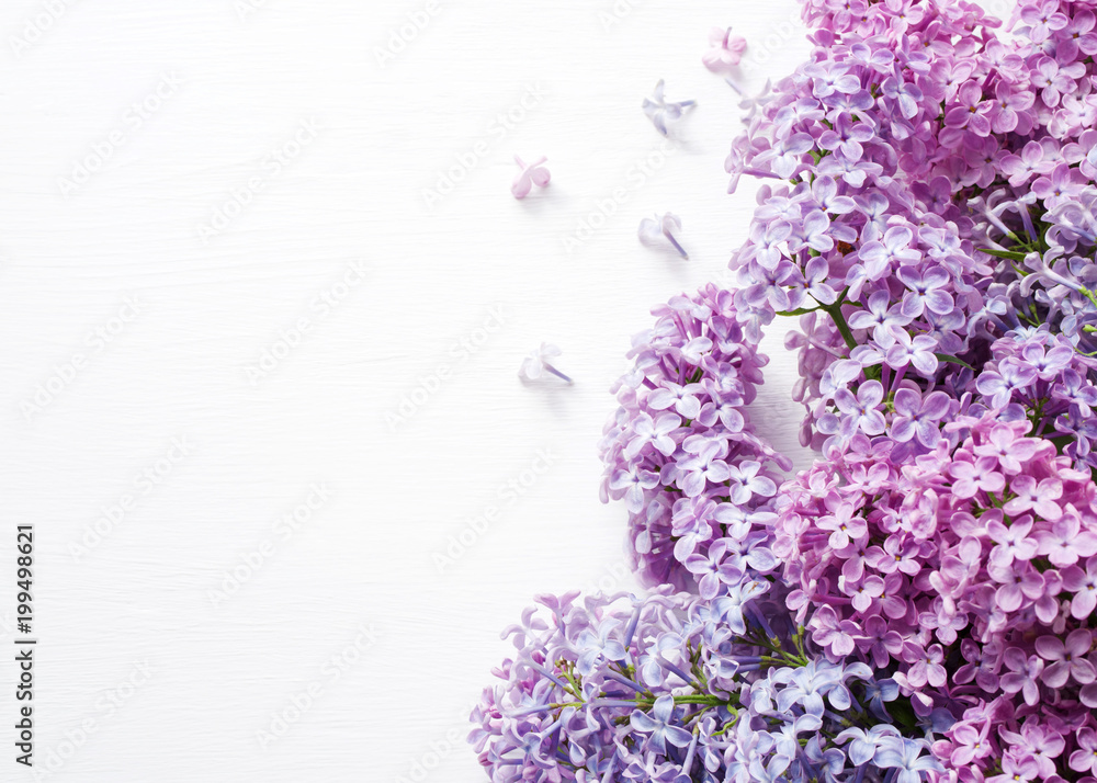 Lilac bouquet of flowers on a white wooden background. Spring bouquet.
