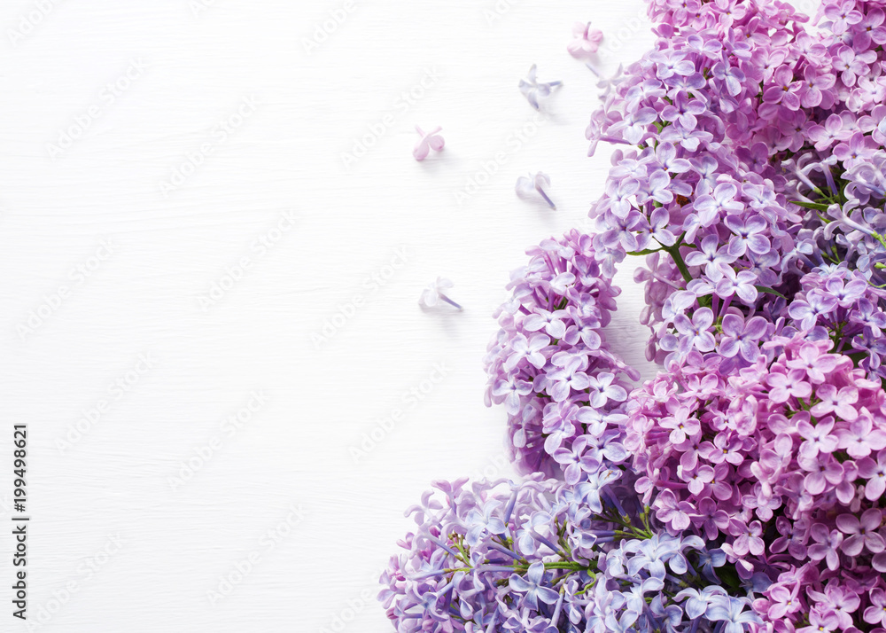 Lilac bouquet of flowers on a white wooden background. Spring bouquet. Lilac bouquet of flowers on a white wooden background. Spring bouquet.