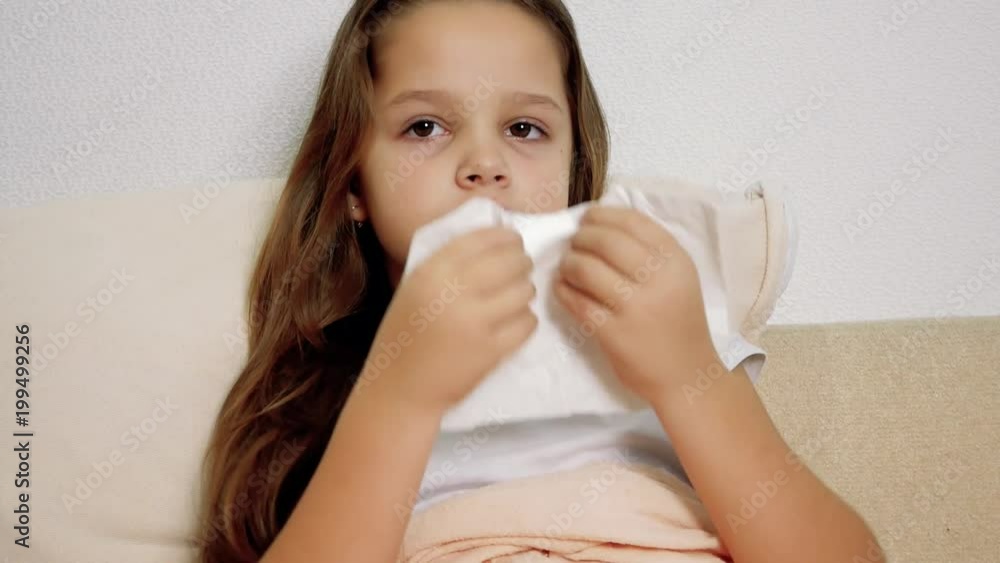ill girl with paper tissue on the bed