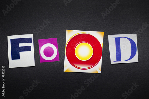letters cut out from newspapers and magazines that form the word "food"", on a black background