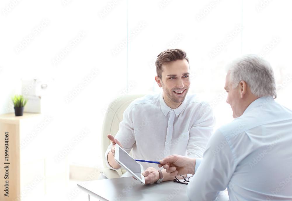 Human resources manager conducting job interview with applicant in office Human resources manager conducting job interview with applicant in office