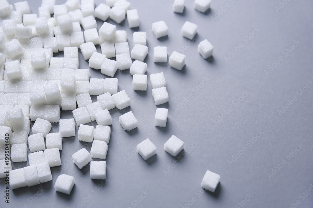 Refined sugar cubes on grey background Refined sugar cubes on grey background
