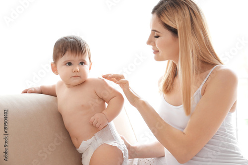 Woman applying body cream o...