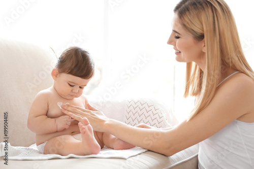 Woman applying body cream o...