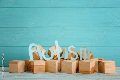 Word "Autism" and wooden cubes on table