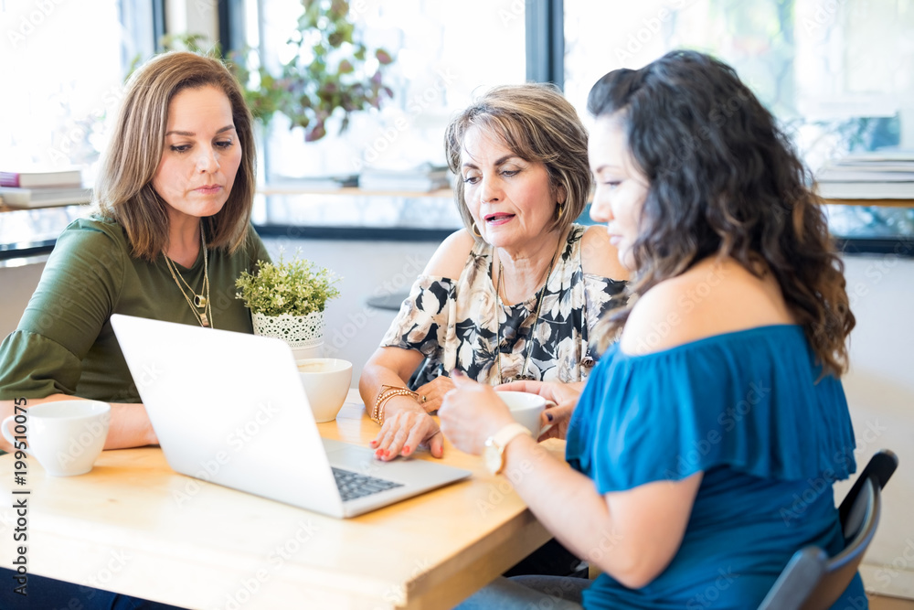 Hispanic women at cafe with laptop Hispanic women at cafe with laptop