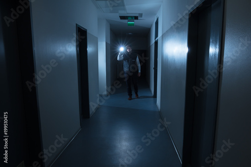 Security Guard Holding Flashlight
