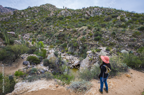 Hispanic woman hiking on a mountain trail near Tucson, Arizona.