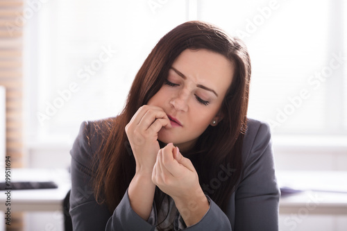 Businesswoman Biting Her Finger Nails