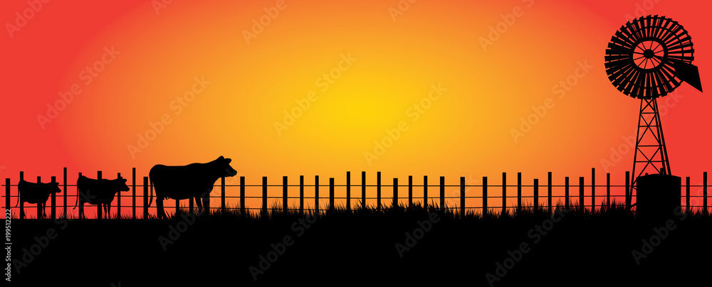 Naklejka premium wind mill in the outback with three cows