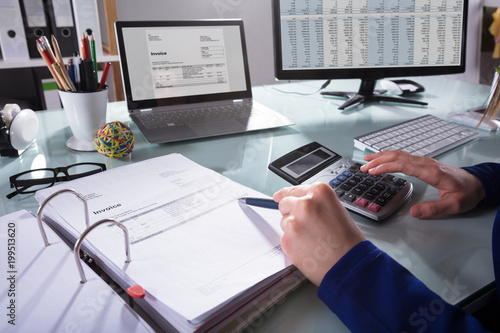 Businessperson Calculating Invoice photo