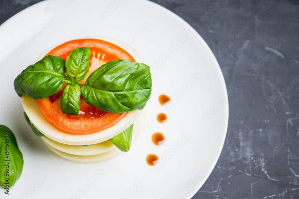 Salad Caprese with mozzarella and tomato. Layers served. Selective focus. Salad Caprese with mozzarella and tomato. Layers served. Selective focus.