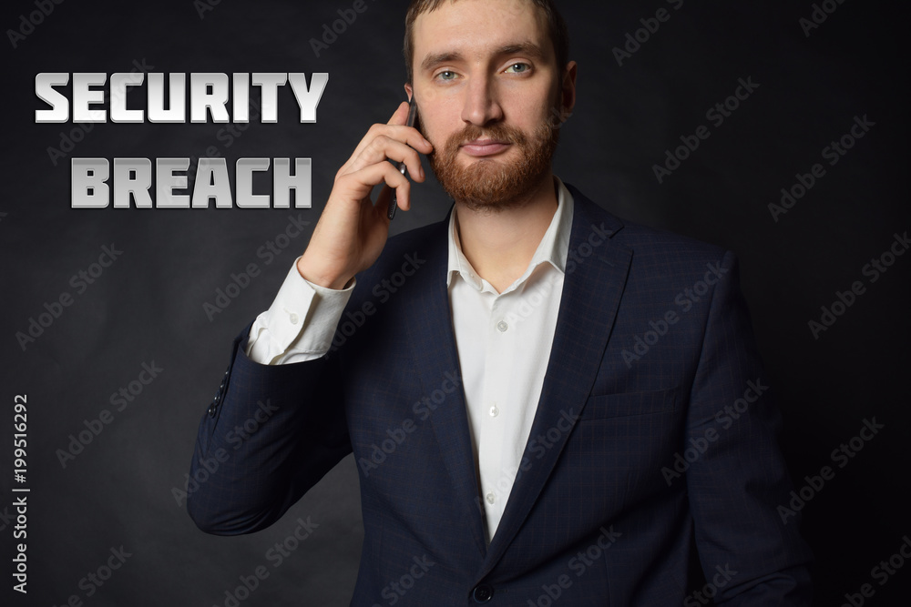 A businessman shows an inscription:SECURITY BREACH A businessman shows an inscription:SECURITY BREACH