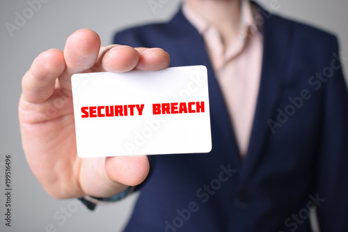 Businessman shows business card with the inscription:SECURITY BREACH