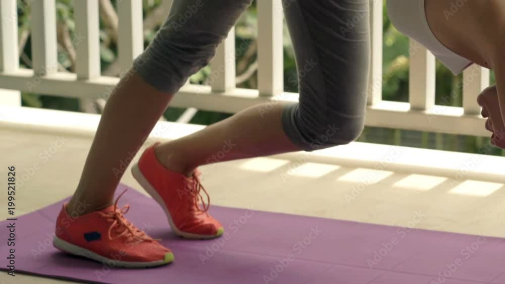 Woman exercising, stretching legs on mat on terrace, super slow motion 240fps
Woman exercising, stretching legs on mat on terrace, super slow motion 240fps