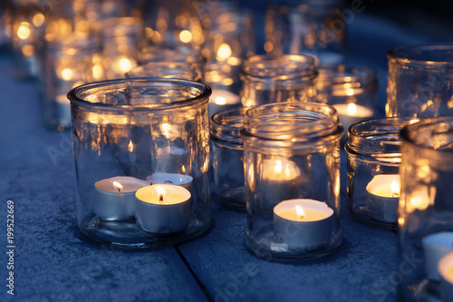 Many lantern made of glass and tealight glowing in the night