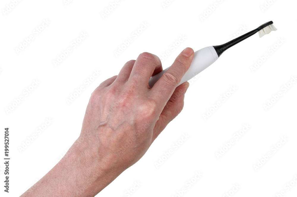 An elderly man holds an electric toothbrush in his hand An elderly man holds an electric toothbrush in his hand
