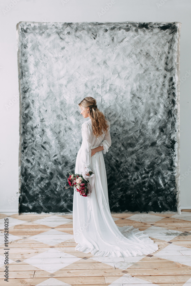 Beautiful young bride in wedding dress on canvas background with pastel, delicate image with bright colors. Restrained gamma and modern trends in photography Beautiful young bride in wedding dress on canvas background with pastel, delicate image with bright colors. Restrained gamma and modern trends in photography