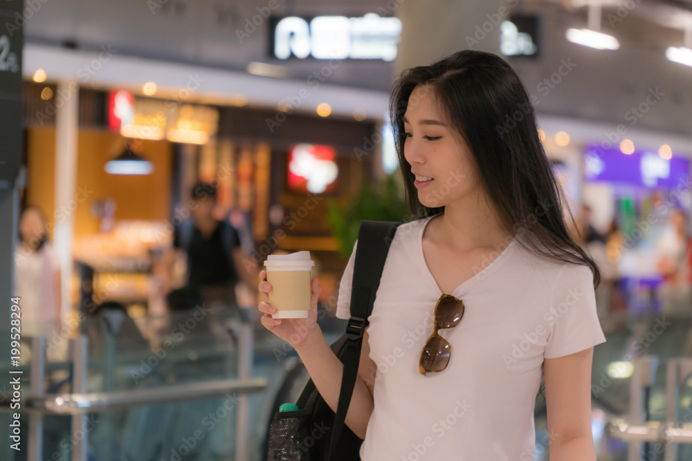 Beautiful young woman drinking coffee..For the hustle and bustle of traveling..Copy space.