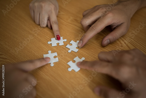 Man hands connecting couple puzzle piece in office. Business solutions, target, successful, goals and strategy concepts © Johnstocker