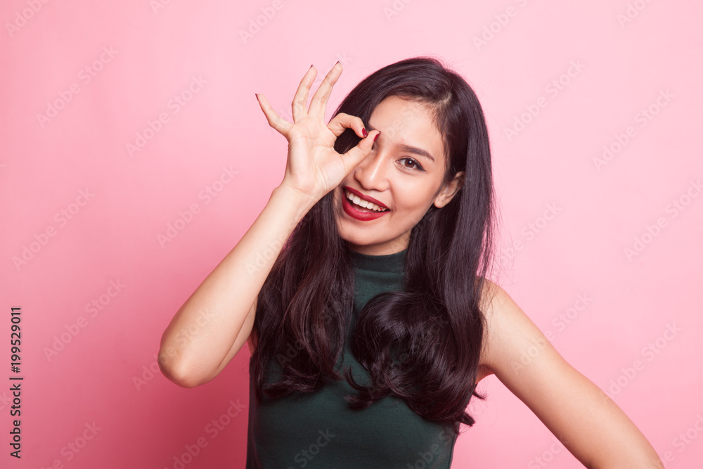 Beautiful young Asian woman show OK sign over her eye. Beautiful young Asian woman show OK sign over her eye.
