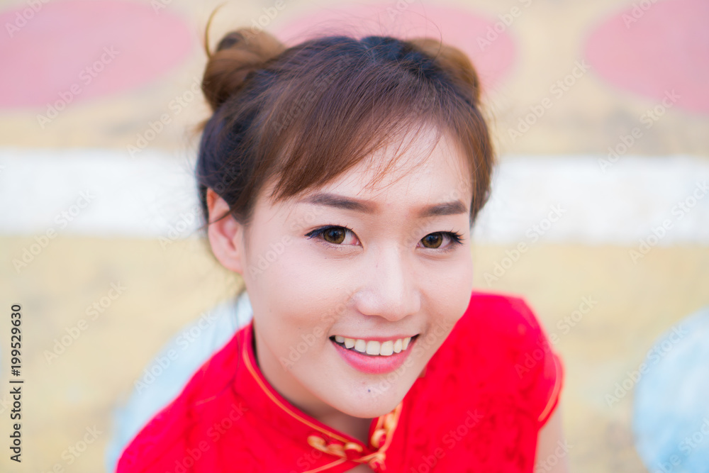 Chinese Girl in Chinese New Year Dress.With a cute smile..smile happily Chinese Girl in Chinese New Year Dress.With a cute smile..smile happily