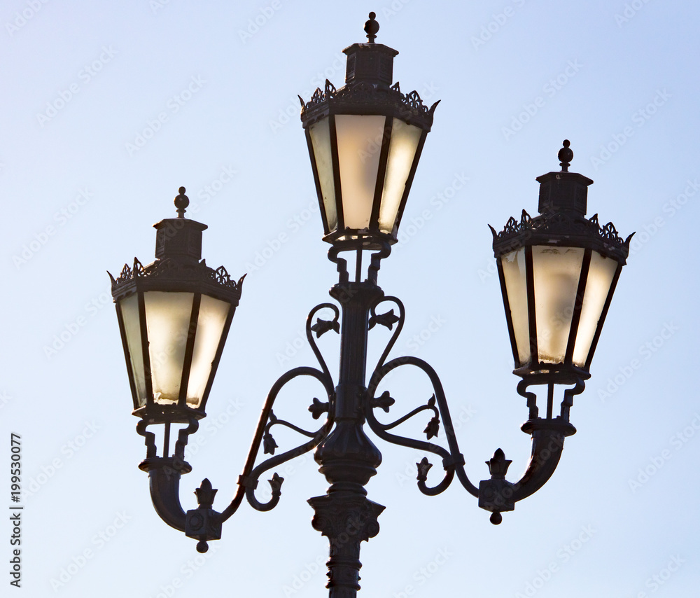 Ancient street lamp on the sky background