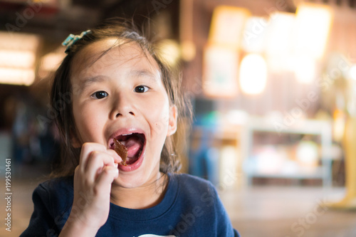 Asian girls eat delicious desserts. And make a happy face.