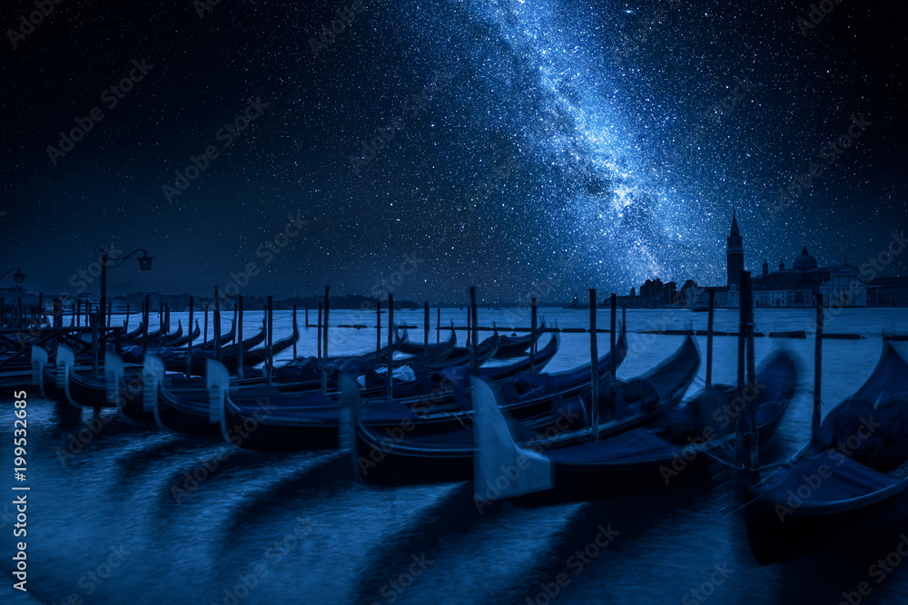 Milky way and swinging gondolas at night, Venice, Italy