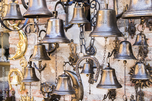 Ship bells hanging from a wall store in the Italian town of Sirmione