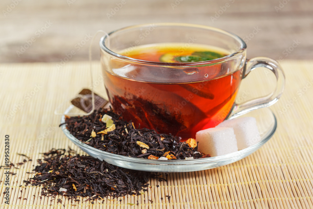 cup of black tea with mint leaves on a wooden table cup of black tea with mint leaves on a wooden table