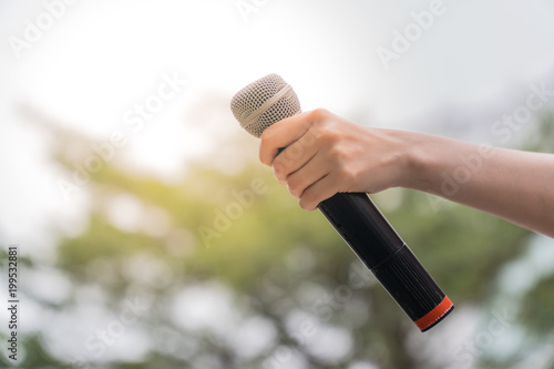 Journalist's hand Holding microphone. In the interview. news report. Black microphone.