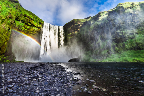 Stunning waterfall Skogafoss and small rainbow, Iceland