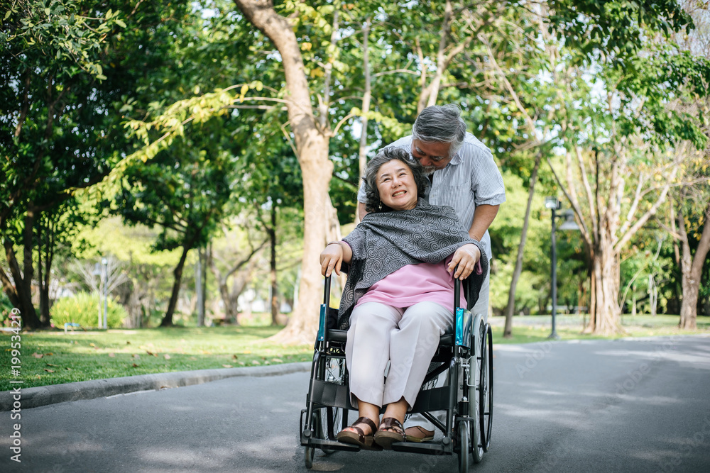 cheerful disabled grandfather in wheelchair welcoming his happy Family cheerful disabled grandfather in wheelchair welcoming his happy Family