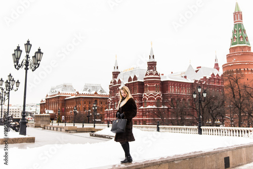 Portrait in full growth, Russian beautiful woman in a mink coat on the Red Square in Moscow in Christmas time
