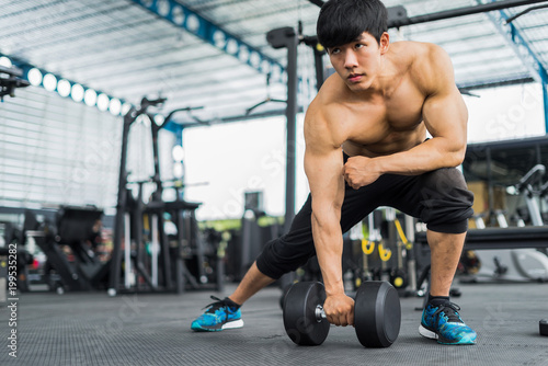 strong fitness man posing muscular body and doing exercises for bodybuilder in the gym, fitness concept, sport concept