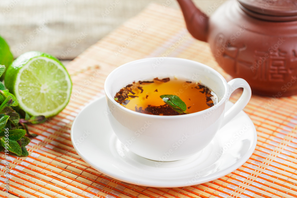 cup of black tea with mint leaves on a wooden table cup of black tea with mint leaves on a wooden table