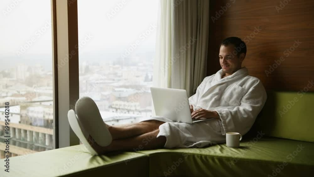 Young man freelancer working from home on a laptop Young man freelancer working from home on a laptop