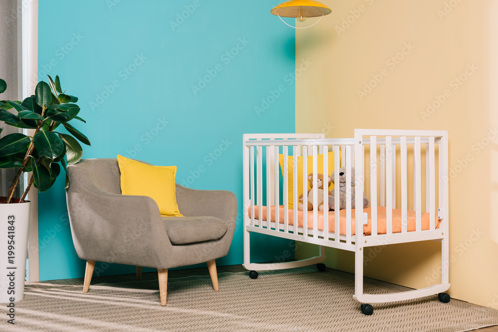 interior of retro styled bright child room with wooden cot interior of retro styled bright child room with wooden cot