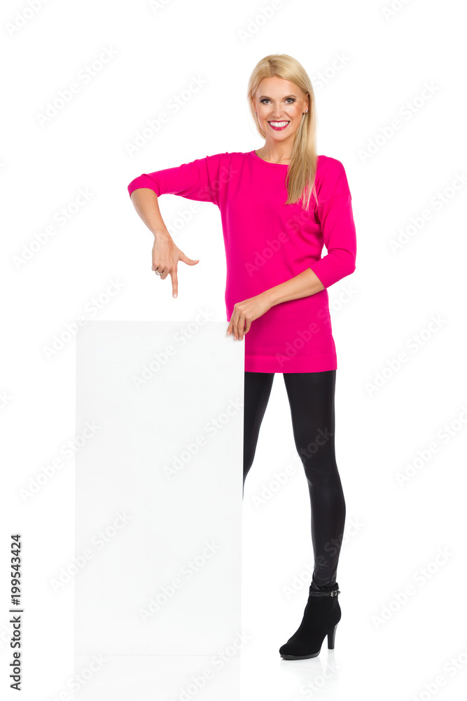Beautiful Blond Woman Is Smiling And Pointing At Blank White Board Beautiful Blond Woman Is Smiling And Pointing At Blank White Board