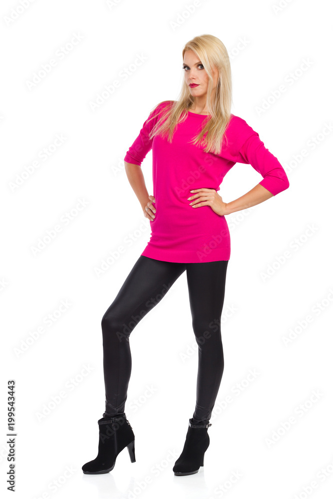 Serious Fashion Model Is Standing With Hands On Hip And Looking At Camera Serious Fashion Model Is Standing With Hands On Hip And Looking At Camera