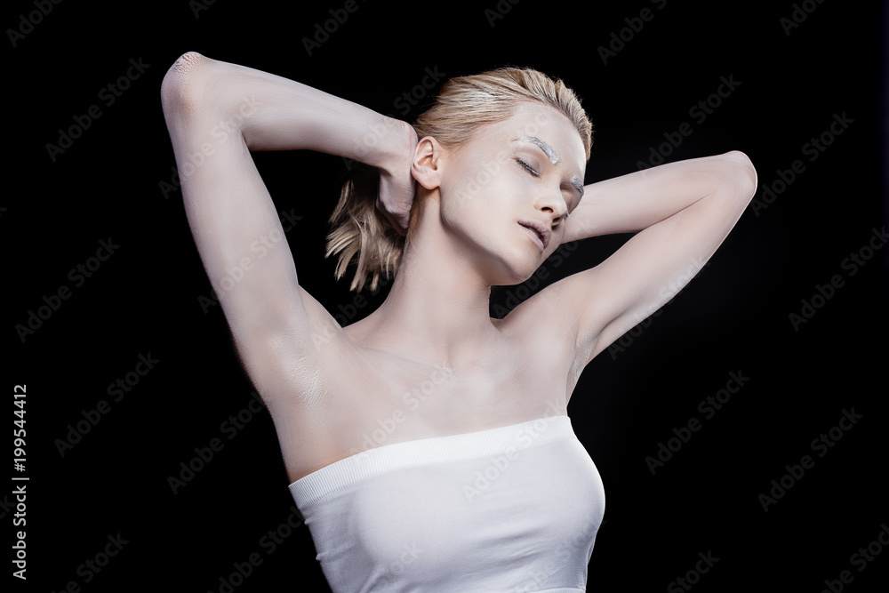 young woman with closed eyes posing with white makeup, isolated on black young woman with closed eyes posing with white makeup, isolated on black