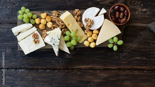 Photos Cheeseboard with various cheeses, fruits and nuts
