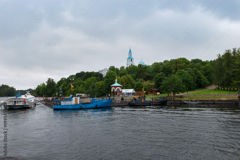 RUSSIA, ISLAND VALAAM - AUGUST 18, 2017: Spaso-Preobrazhensky Valaam Stauropegial Monastery, Monastery Bay. Ships and a meteor at the pier