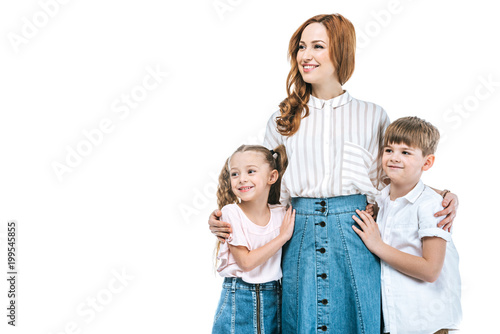 happy mother with adorable kids standing together and looking away isolated on white